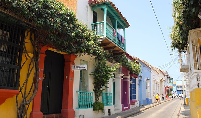 Colorful houses and balconies in Cartagena painted bright colors with lots of greenery