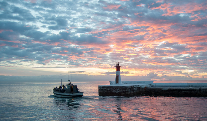 a fishing boat in Kalk Bay at sunset, South Africa