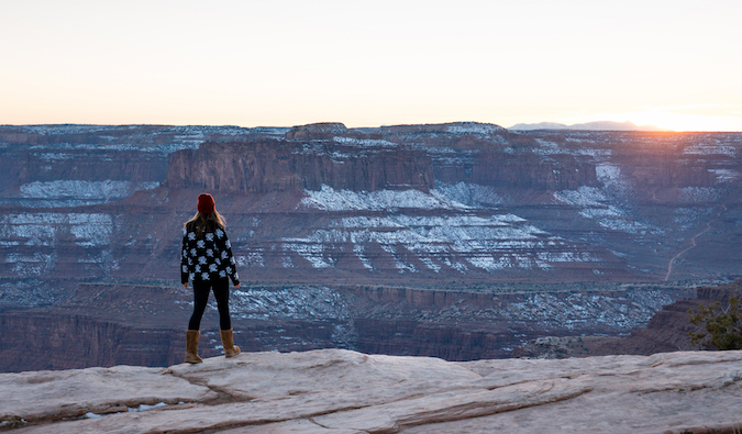 Kristin Addis standing in front of the Grand Canyon with some light snow