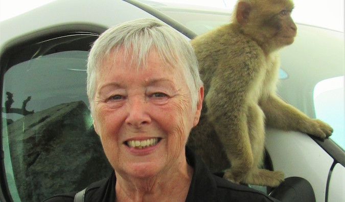 Sherrill with a monkey on her shoulder on a trip overseas