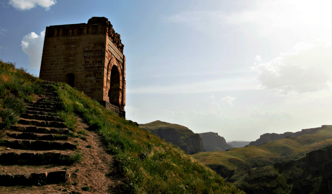 a scenic view in Azerbaijan looking out over rugged terrain with a historic building in the distance