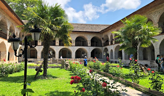 a verdant, green courtyard in Azerbaijan bursting with plants and trees