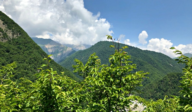 Lush, towering mountains in rural Azerbaijan on a sunny summer day