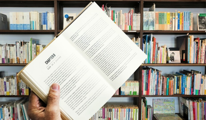 A man holding an open book