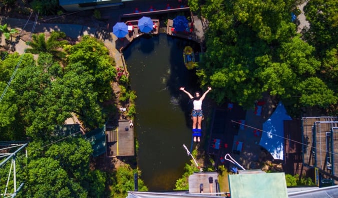 Someone jumping from a tall bungy platform in Cairns, Australia