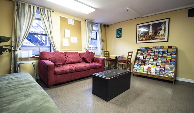 Basic common area with couches and rack of brochures at Chelsea Hostel in NYC