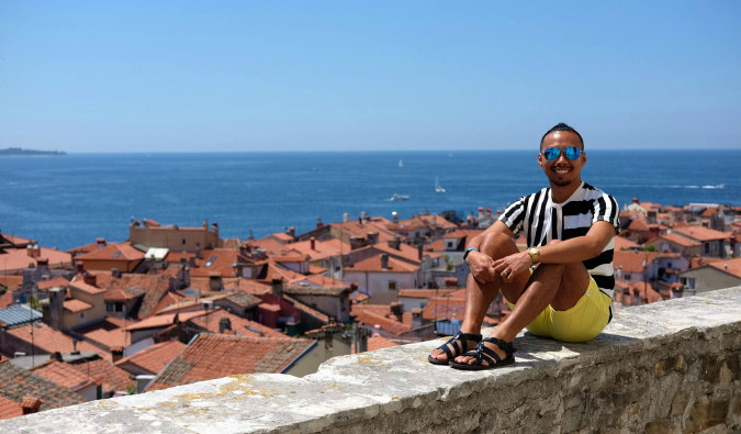 DJ, a solo traveler from the Philippines posing for a photo in Europe