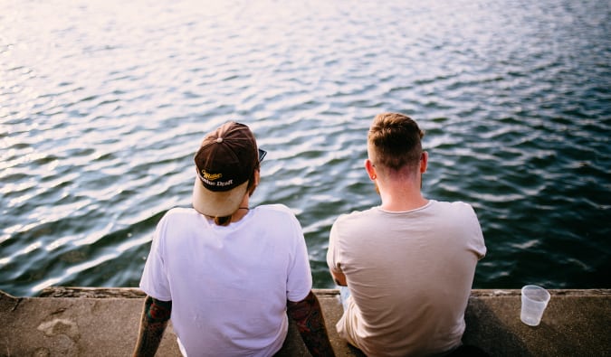 Two travelers chatting by the water together