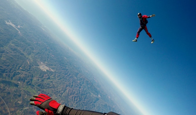 A traveler skydiving from an airplane solo