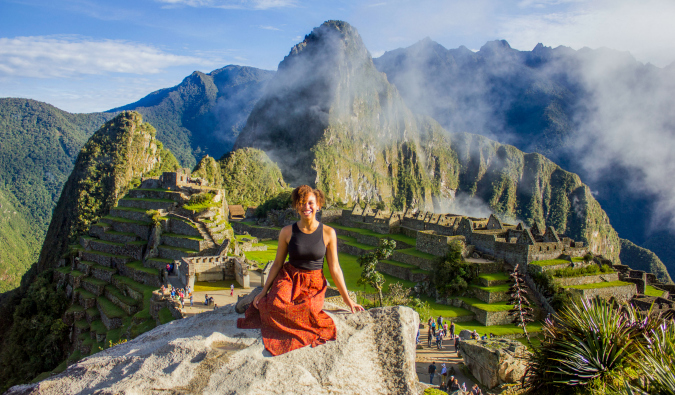 Heather, a solo female traveler, posing at Machu Picchu in Peru