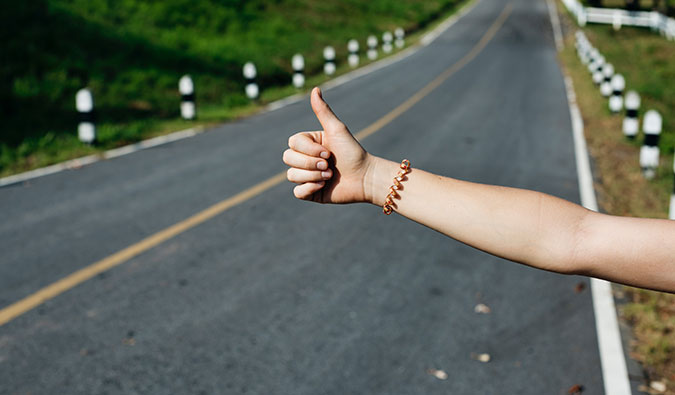 A hitchhiker on a green road