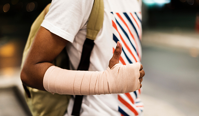 a man wearing a cast gives the thumbs up