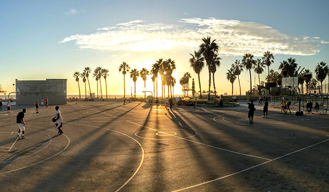 People playing basketball in Los Angeles during sunset