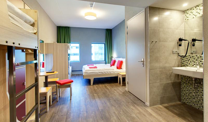 Large room with bunk bed and double bed at Meininger Amsterdam Hostel