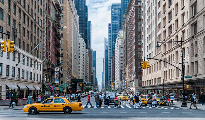 A busy intersection with a yellow cab in New York City