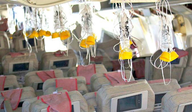 oxygen masks in an airplane cabin; Public Domain image