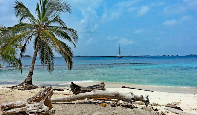 A secluded beach with a sailboat in Panama