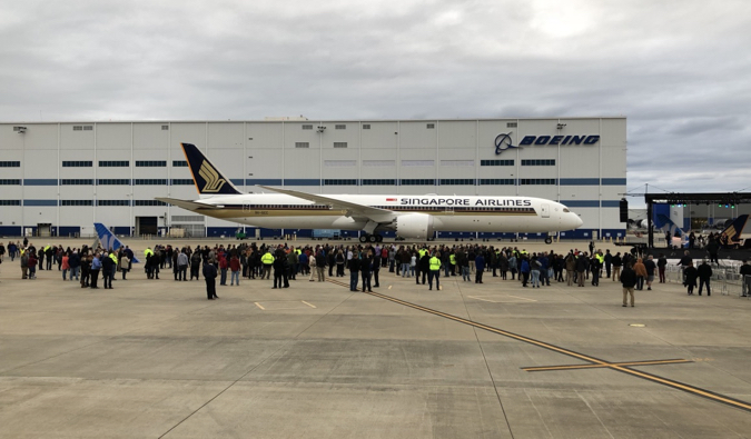 A large Boeing Dreamliner parked at an airport