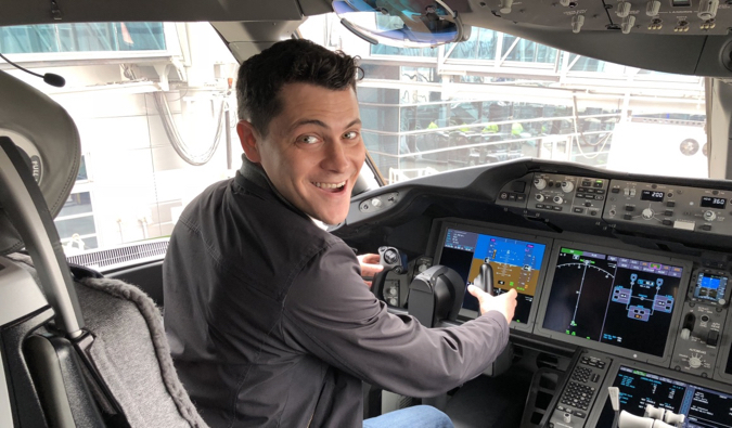 Nomadic Matt in the cockpit of a Boeing aircraft