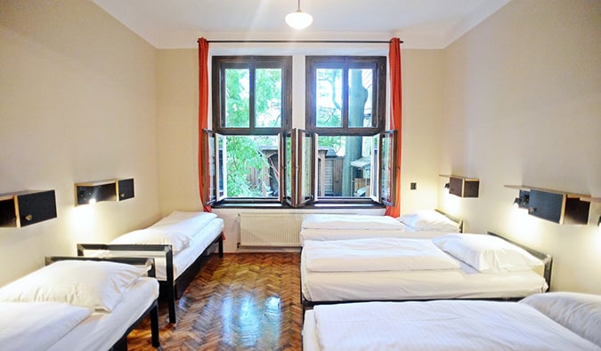 Dorm room with 5 single twin beds and minimal décor at Sir Toby's hostel in Prague