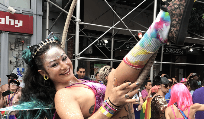 a woman with a hula hoop and dressed in glitter during gay pride parade