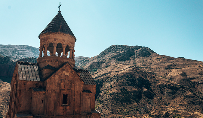 a church with a mountain backdrop in Armenia