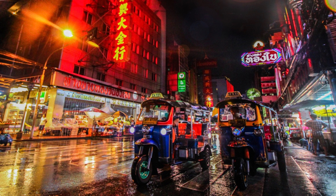 A bright shot at night of tuk-tuks in Southeast Asia