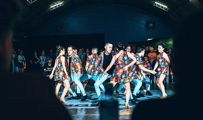 people performing the salsa in a darkened room in Cali, Colombia