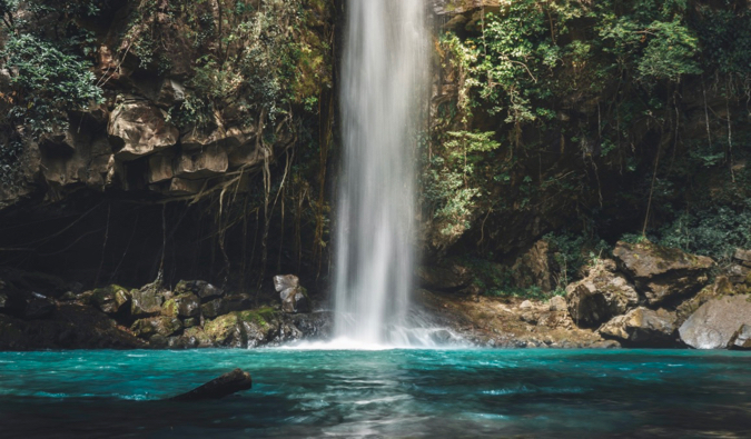 A moody photo of a beautiful waterfall in Costa Rica