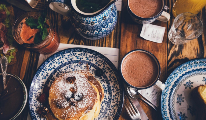 a delicious pancake breakfast with berries and coffee