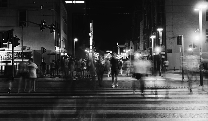 black and white photo of a busy crosswalk with blurred people