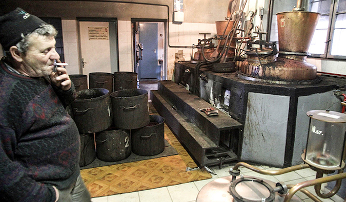 a man smokes a cigarette at the Szeszföde distillery in Mezöberény, Hungary