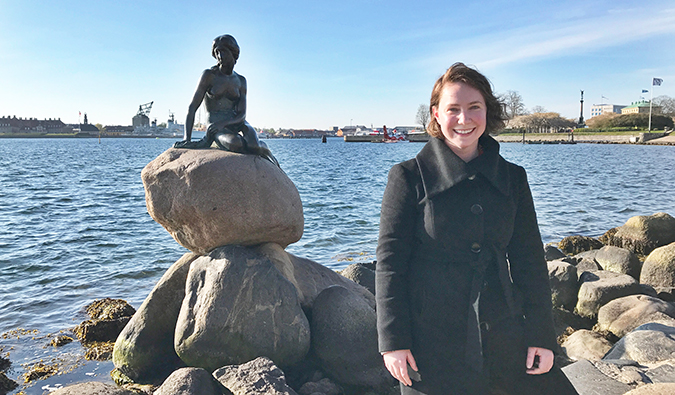 Kathleen with a statue on a rock