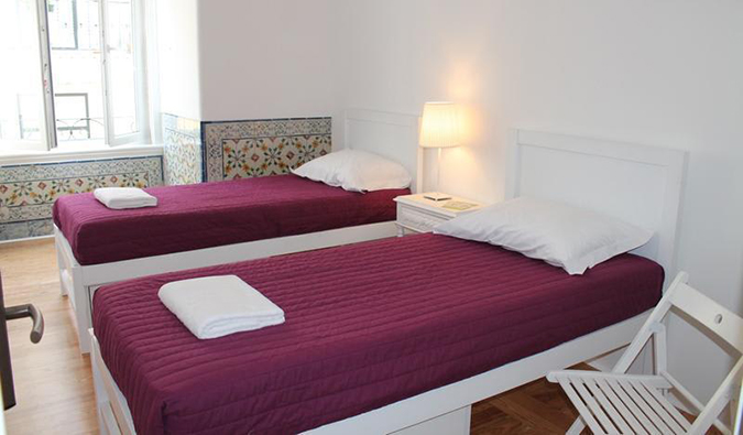 Two twin beds in white room at Lost Inn Lisbon, Lisbon