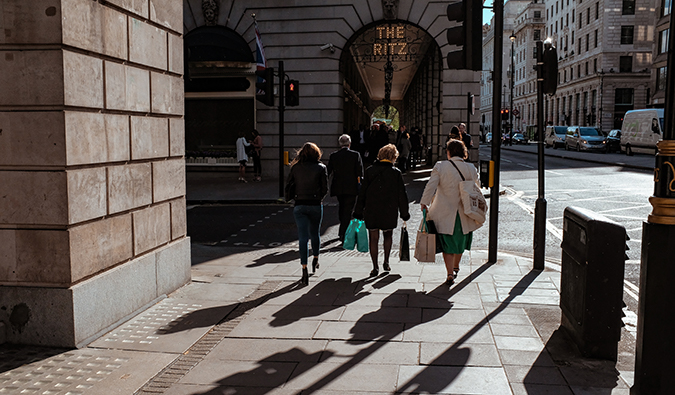 people with shopping bags walking around Mayfair