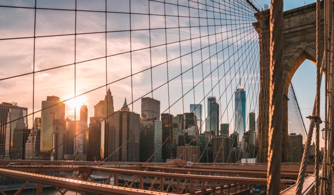 A shot of Manhattan from the Brooklyn Bridge during sunset in the summer