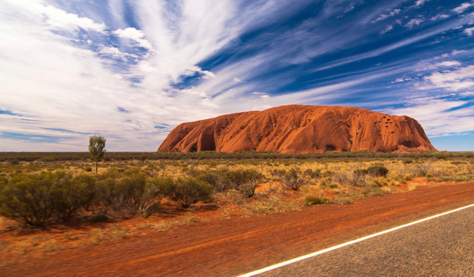 The famous Uluru rock in Australia, as seen from the nearby road