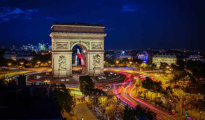 The Arc de Triomphe lit up in the evening, in Paris