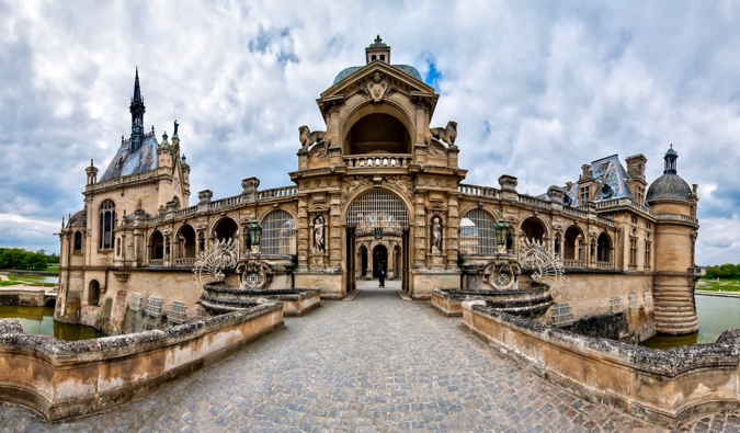 The intricate stone architecture of the historic Chantilly chateau in France