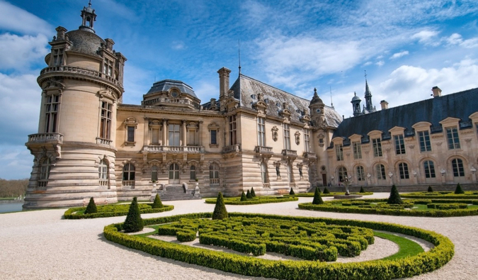 The historic Chantilly chateau in France surrounded by its beautiful gardens