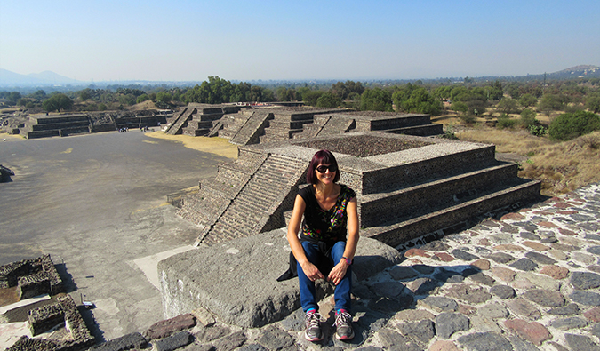 Sarah sitting near some ancient ruins