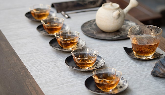 a tea house in Taiwan with a teapot ready to pour into cups