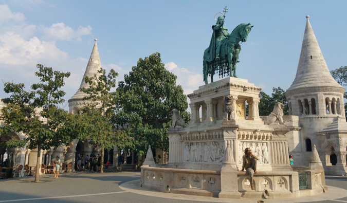 A solo female traveler sitting at Fisherman's Bastion in Budapest, Hungary