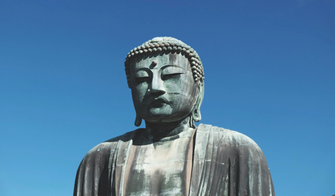 The Great Buddha in Kamakura, Kapan against a bright blue sky