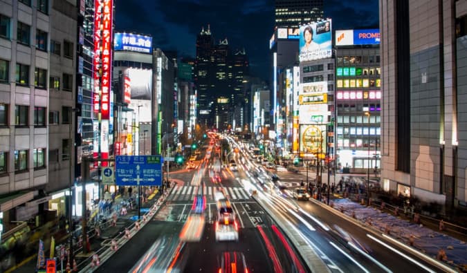 the bright signs and busy streets of Tokyo at night