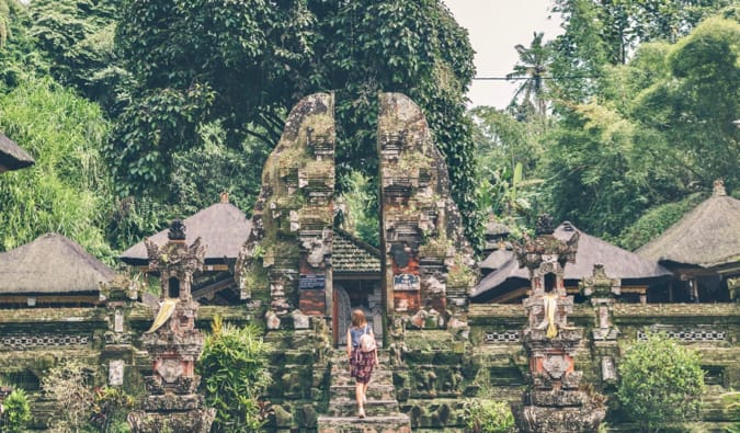 A solo female traveler exploring a temple in Asia