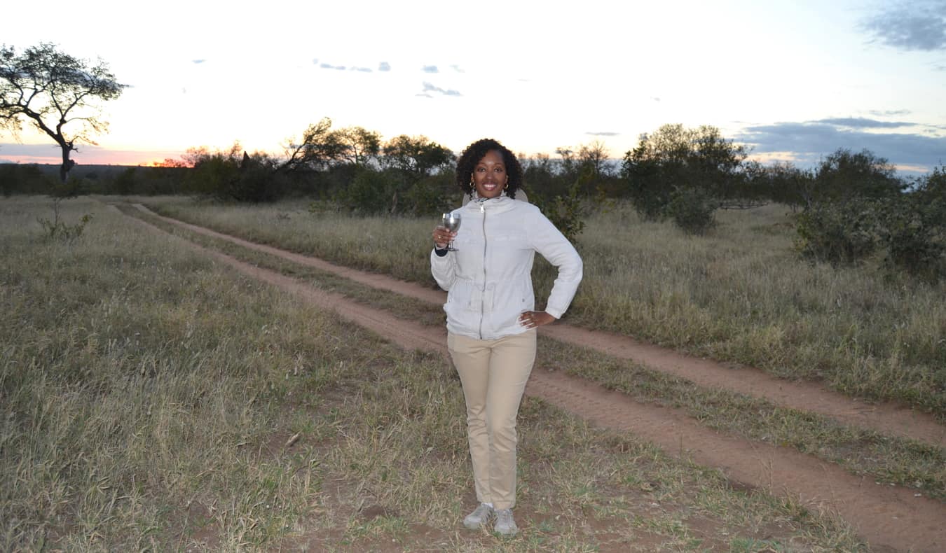 Senitra, a solo black female traveler posing while on safari in Africa