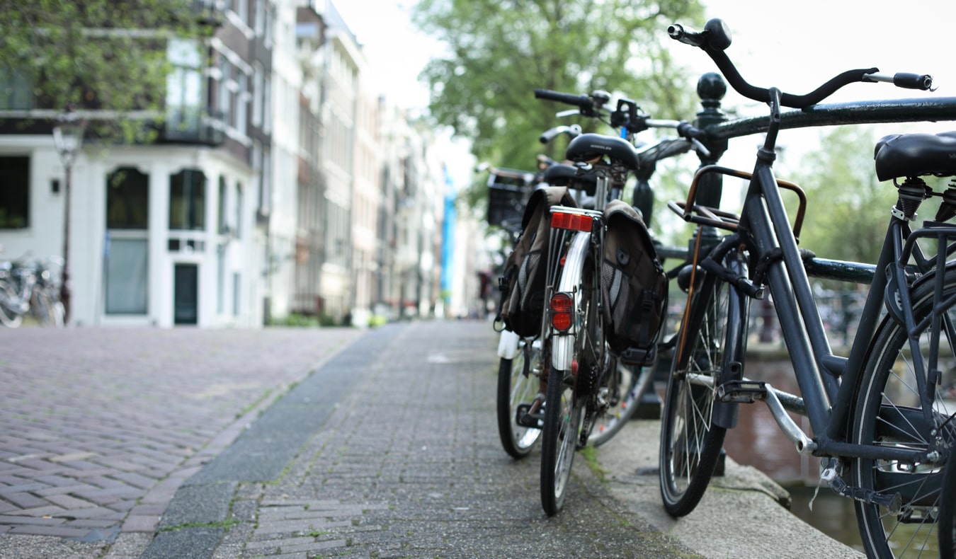 Bikes in Amsterdam chained up to one of the many bridges