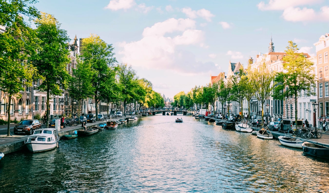 A boat tour of the canals of Amsterdam on a sunny day