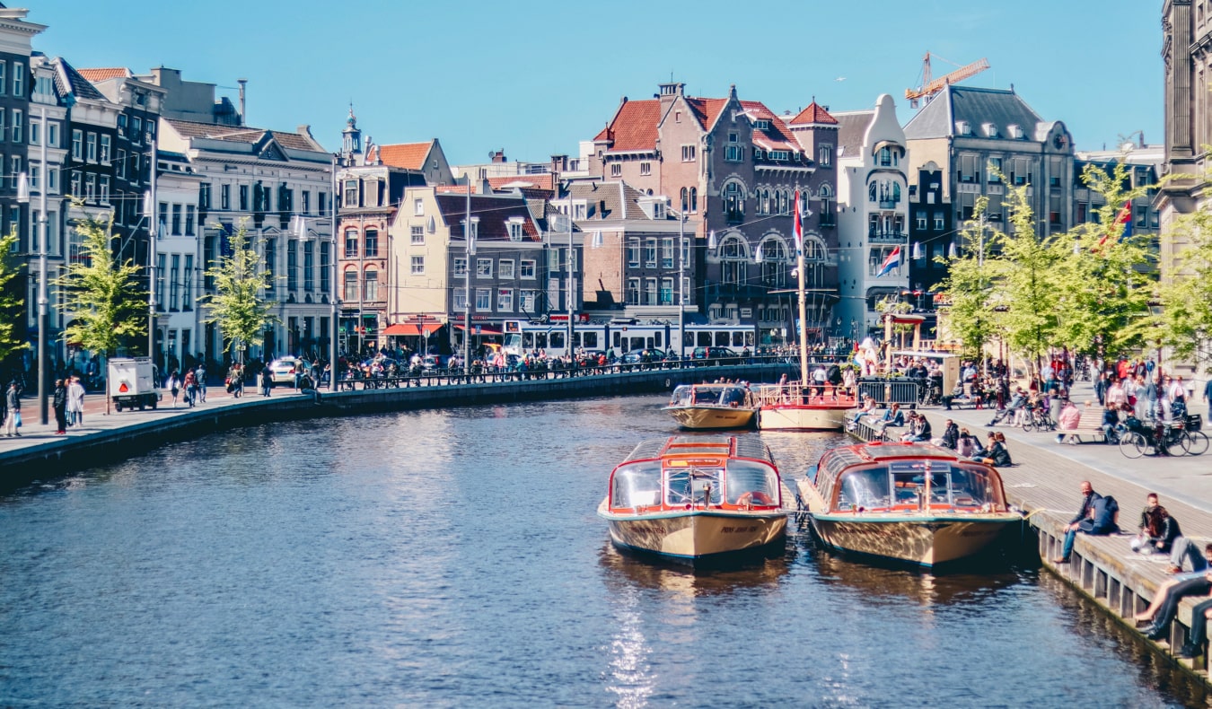 People relaxing along the canals of Amsterdam, the Netherlands